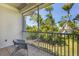 Tiled patio with a wicker chair, overlooking a serene outdoor space with mature trees at 3803 54Th W Dr # 203, Bradenton, FL 34210