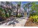 Charming single-story home with mature landscaping and a long driveway at 4062 S Shade Ave, Sarasota, FL 34231