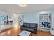 Cozy living room with hardwood floors, custom shelving, and an adjacent dining area at 4062 S Shade Ave, Sarasota, FL 34231