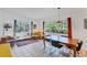 Bright living room featuring tile floors, multiple seating options, and natural light from large windows at 4062 S Shade Ave, Sarasota, FL 34231