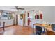 Home office setup with hardwood floors, ceiling fan, and views into the kitchen and backyard at 4062 S Shade Ave, Sarasota, FL 34231