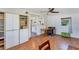 Home office features hardwood floors, large storage cabinet, ceiling fan and adjacent kitchen access at 4062 S Shade Ave, Sarasota, FL 34231