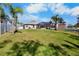 Spacious backyard with manicured lawn, and a screened-in pool at 4110 Noble Pl, Parrish, FL 34219