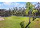 Expansive backyard features green grass, landscaping and a screened-in pool at 4110 Noble Pl, Parrish, FL 34219