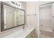 Bathroom featuring a white countertop, framed mirror, and a shower-tub combo at 4110 Noble Pl, Parrish, FL 34219