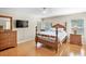 Bedroom with a wooden bed frame, ceiling fan, and wood-style tile floors at 4110 Noble Pl, Parrish, FL 34219