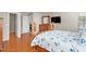 Bedroom with a wooden bed frame, TV, and wood-style tile floors at 4110 Noble Pl, Parrish, FL 34219