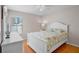 Bright bedroom with a large window and a comfortable bed and white furniture at 4110 Noble Pl, Parrish, FL 34219