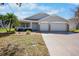 Charming single-story home featuring a three-car garage, covered porch, and well-maintained landscaping at 4110 Noble Pl, Parrish, FL 34219