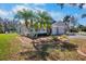 Attractive single story home with a well manicured lawn, tropical palms, and a three car garage at 4110 Noble Pl, Parrish, FL 34219