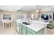Open-concept kitchen featuring a breakfast bar, double sink, and view of the living area at 4110 Noble Pl, Parrish, FL 34219