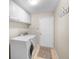 Functional laundry room equipped with a washer, dryer, and storage cabinets at 4110 Noble Pl, Parrish, FL 34219