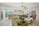 Relaxing living room with tile floors and a kitchen with barstool seating and views to the patio at 4110 Noble Pl, Parrish, FL 34219