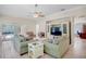Sun-lit living room with sliding doors to outdoor pool and access to office area at 4110 Noble Pl, Parrish, FL 34219