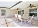 Relaxing covered patio with ceiling fans and outdoor dining set at 4110 Noble Pl, Parrish, FL 34219