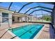 Screened-in pool area with an outdoor dining space, perfect for relaxation and entertainment at 4110 Noble Pl, Parrish, FL 34219