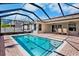 Sparkling pool area with a screened enclosure and outdoor seating at 4110 Noble Pl, Parrish, FL 34219