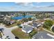 Aerial view of a suburban neighborhood featuring homes and a tranquil lake at 4202 Donnington Dr, Parrish, FL 34219