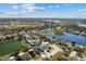 Aerial view of a home within a lake-filled residential community at 4202 Donnington Dr, Parrish, FL 34219