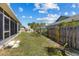 Large backyard boasts green grass, a new fence, and ample space for outdoor activities and entertaining at 4202 Donnington Dr, Parrish, FL 34219