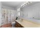 Cozy bathroom featuring vanity, mirror and a shower/tub with a playful patterned curtain at 4202 Donnington Dr, Parrish, FL 34219