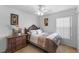 Cozy bedroom with a comfortable bed, classic furniture, and a decorative ceiling fan, creating a serene and inviting atmosphere at 4202 Donnington Dr, Parrish, FL 34219