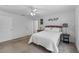 Relaxing bedroom features neutral decor, plush bedding, and ample natural light for a serene retreat at 4202 Donnington Dr, Parrish, FL 34219