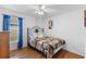 Inviting bedroom with a wrought iron bed frame, bright natural light, and wood flooring, offering comfort and style at 4202 Donnington Dr, Parrish, FL 34219
