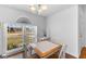 Bright dining area with hardwood floors, features a chandelier and a large window with pleasant outdoor views at 4202 Donnington Dr, Parrish, FL 34219