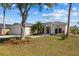 Single-story home with two-car garage, well-manicured lawn, and lovely landscaping at 4202 Donnington Dr, Parrish, FL 34219