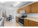 Eat-in kitchen features bright, natural light, a complete set of appliances, and traditional wood cabinets at 4202 Donnington Dr, Parrish, FL 34219