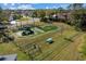 Fenced community playground with play structures, swings, and picnic tables on a grassy surface at 4202 Donnington Dr, Parrish, FL 34219