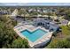 Aerial view of community pool features a well-maintained deck with lounge chairs, spa, and clubhouse at 4202 Donnington Dr, Parrish, FL 34219
