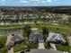 Aerial view of a residential area, home with a screened-in pool, adjacent to a golf course and pond at 4306 Presidential Avenue E Cir, Bradenton, FL 34203