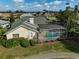 Aerial view of backyard with enclosed pool, landscaping, and a view of the greenway at 4306 Presidential Avenue E Cir, Bradenton, FL 34203