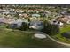 Aerial view of neighborhood and home featuring an enclosed pool and golf course at 4306 Presidential Avenue E Cir, Bradenton, FL 34203
