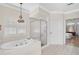 Luxurious bathroom with a soaking tub, glass-enclosed shower, and view into the Primary bedroom at 4306 Presidential Avenue E Cir, Bradenton, FL 34203