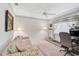 Cozy bedroom with a floral sofa, treadmill, and a window with a view at 4306 Presidential Avenue E Cir, Bradenton, FL 34203
