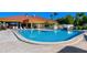 Large community pool with surrounding lounge chairs for relaxing and enjoying the sunny outdoors at 4306 Presidential Avenue E Cir, Bradenton, FL 34203