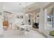 Light-filled dining room with tiled floor, white dining set, and backyard access at 4306 Presidential Avenue E Cir, Bradenton, FL 34203