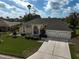 Aerial view of a home featuring manicured landscaping, a paved driveway and a two-car garage at 4306 Presidential Avenue E Cir, Bradenton, FL 34203