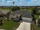 Aerial view of a single-story home, landscaped yard, a paved driveway and pond views at 4306 Presidential Avenue E Cir, Bradenton, FL 34203