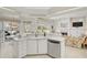 Bright open kitchen with island, stainless dishwasher, and view to living area at 4306 Presidential Avenue E Cir, Bradenton, FL 34203