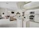 Bright kitchen with island, stainless appliances, and view to living area with fireplace at 4306 Presidential Avenue E Cir, Bradenton, FL 34203