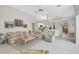 Open living room with tile floors, ceiling fan, and views of the kitchen and dining area at 4306 Presidential Avenue E Cir, Bradenton, FL 34203