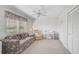 Comfortable living room with floral sofa, desk and chair, and closet space at 4306 Presidential Avenue E Cir, Bradenton, FL 34203