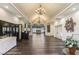Expansive lobby area featuring elegant chandeliers, dark wood floors, and a plant for added ambiance at 4306 Presidential Avenue E Cir, Bradenton, FL 34203