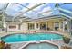 Inviting pool with a screened enclosure, patio, and spa, surrounded by lush landscaping at 4306 Presidential Avenue E Cir, Bradenton, FL 34203