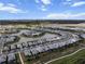 Scenic aerial view of a residential community surrounding a picturesque lake, showcasing beautiful homes and serene landscaping at 4793 Antrim Dr, Sarasota, FL 34240