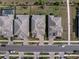 High angle shot of the rooflines and driveways of a neighborhood's homes with manicured lawns and street views at 4793 Antrim Dr, Sarasota, FL 34240